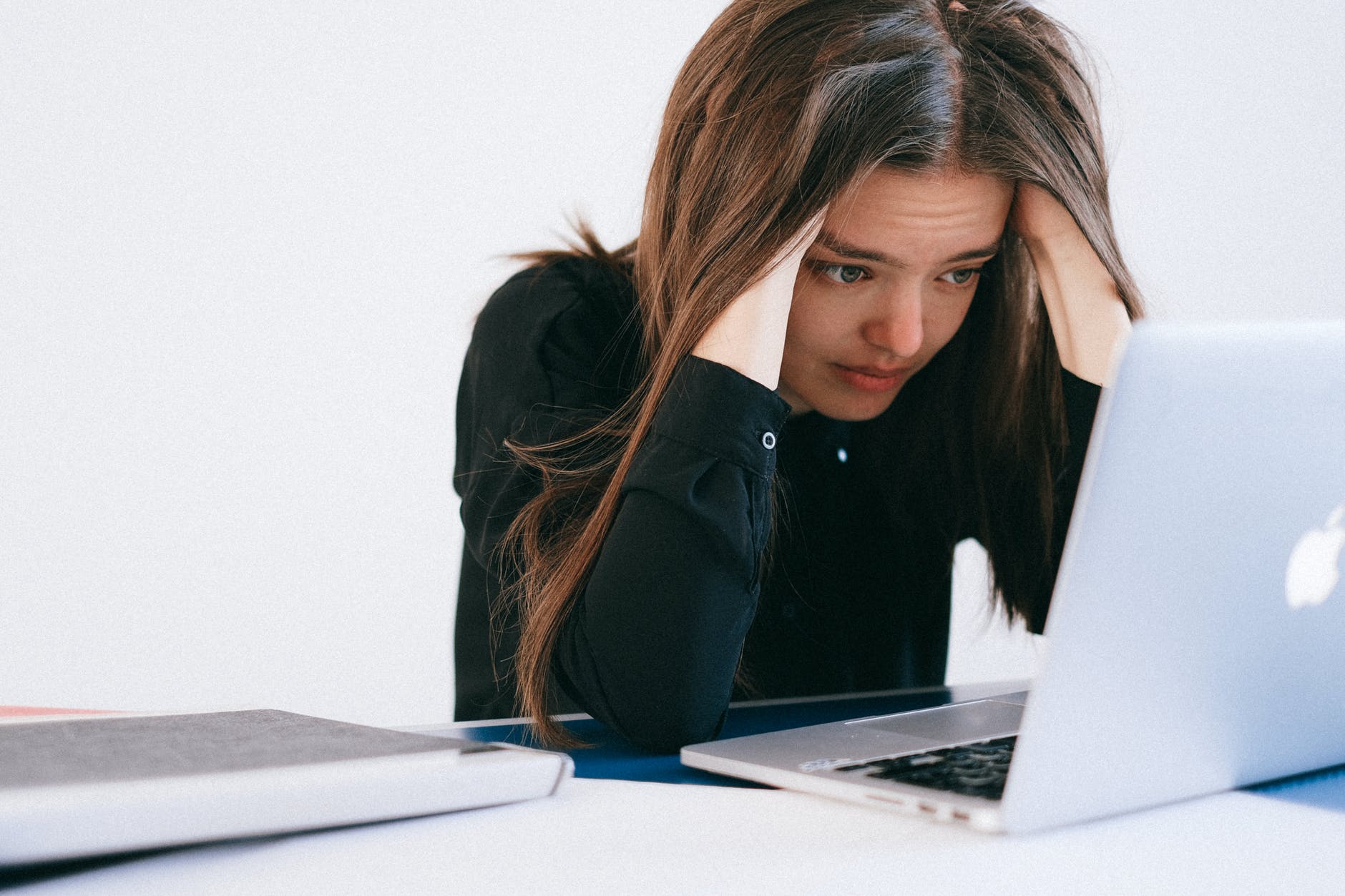 Woman procrastinating at a laptop.