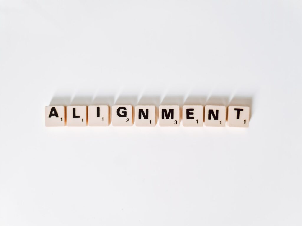 The word alignment spelled in scrabble tiles