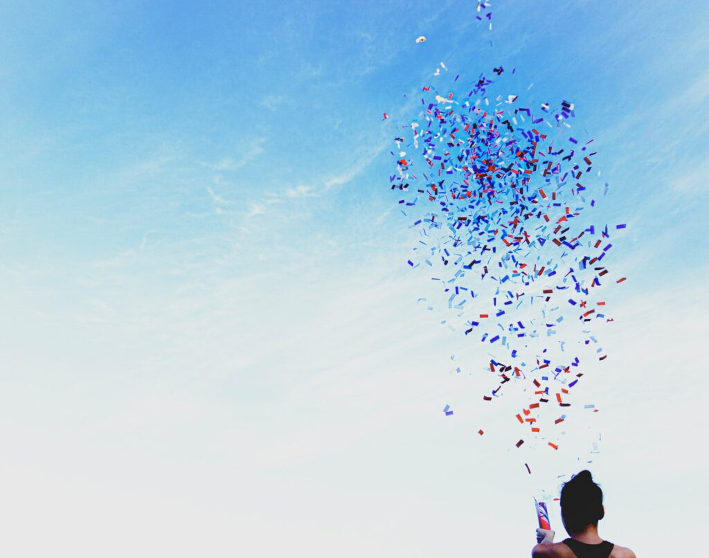 Woman shooting confetti into the air