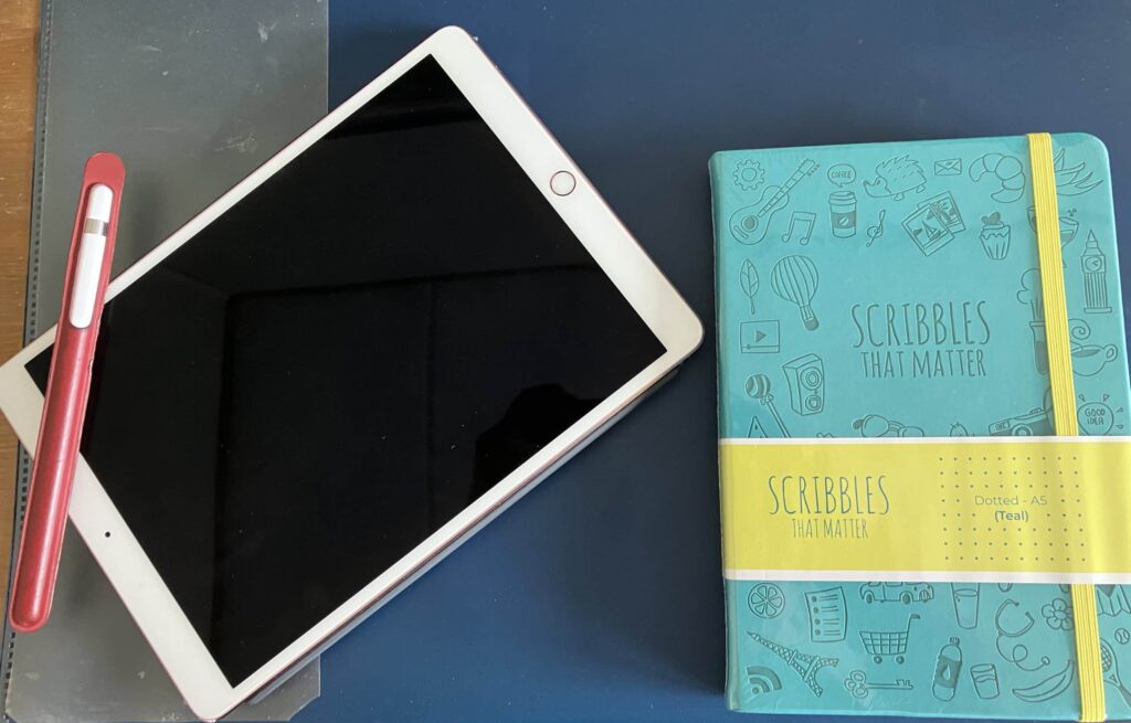 Image showing a notebook, an iPad and an Apple pencil.