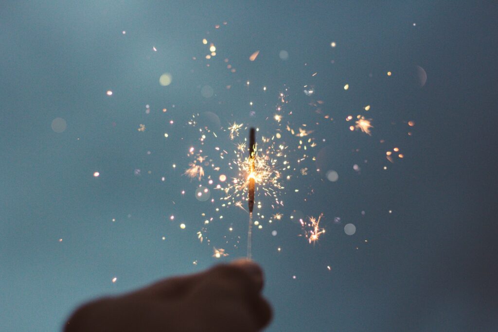 Image of a hand holding a sparkler.