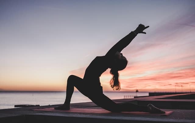 Silhouette photography of a woman doing yoga.